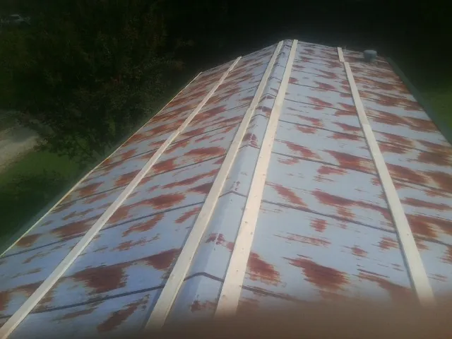 Rusted metal roof panels with new wood purlins before replacement — Storm Damage Roof Repair in Annapolis by Roofing Brothers