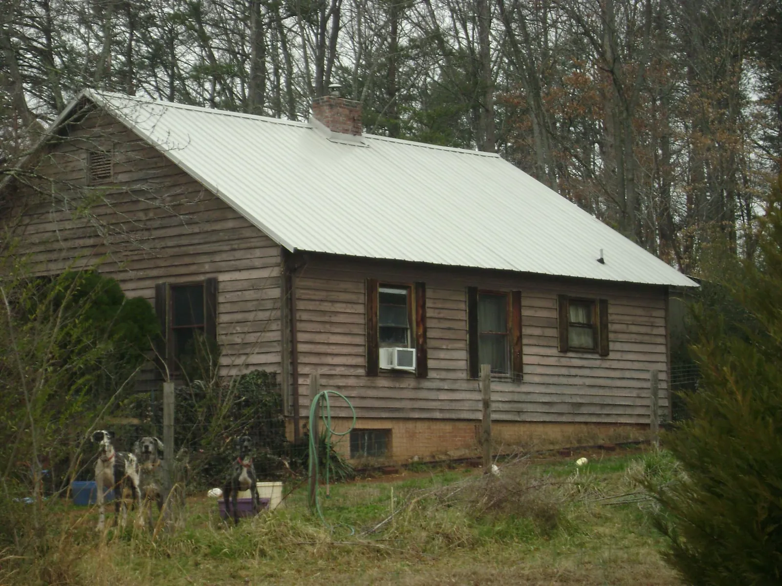 White metal roof on an old wood sided farmhouse, from a Metal Roof Installation job in Annapolis